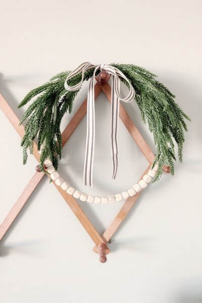 Completed farmhouse evergreen wood bead wreath DIY.