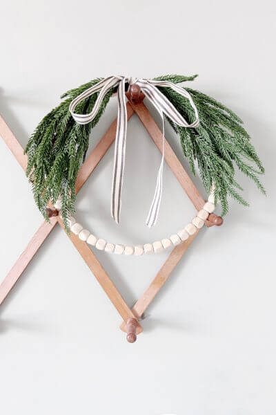 Completed easy farmhouse evergreen wood bead wreath DIY.