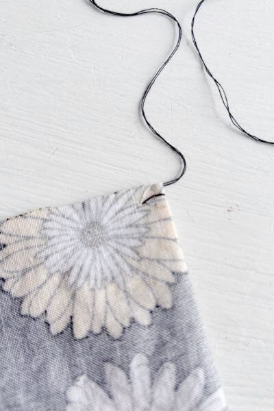 Push the thread all the way through the fabric.