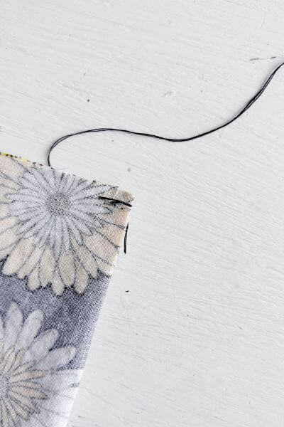 Pull the thread through to the back.