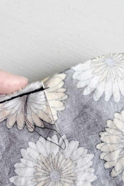 Push the needle part way through the fabric.