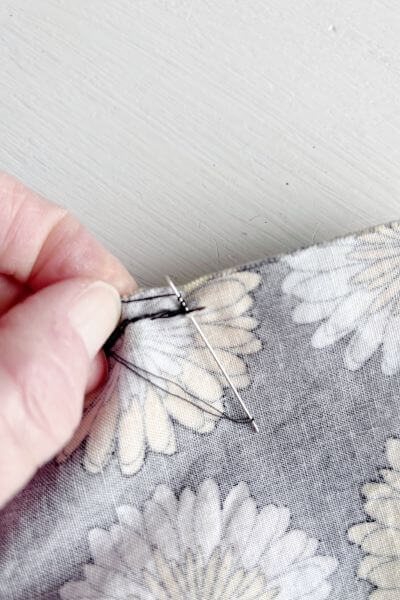 Make three loops around the upper portion of the needle.