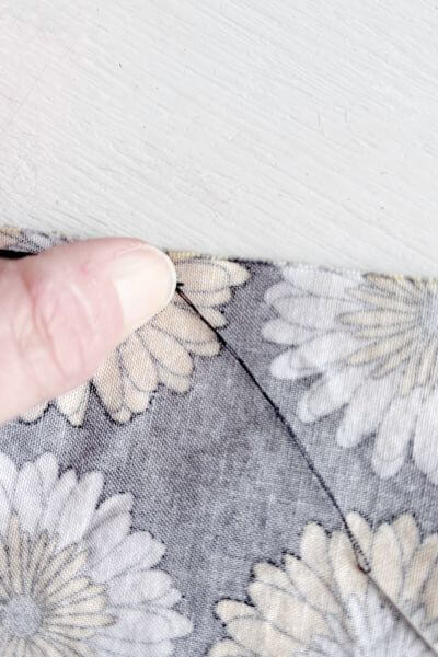 Pull the needle through making the knot.