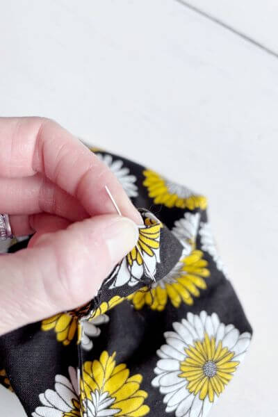 Hold the loops down at the fabric.