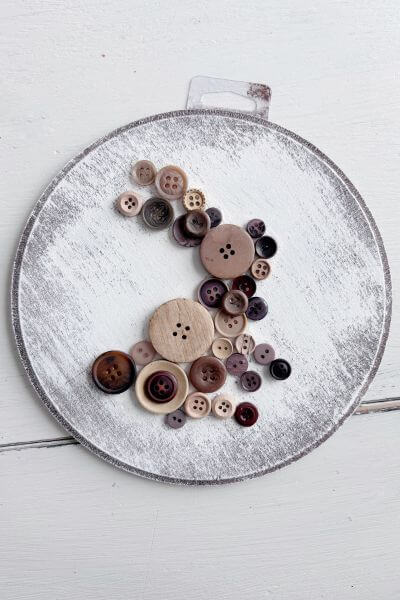 First rabbit design using buttons on wood round.