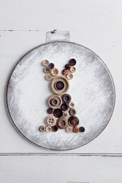 Third rabbit design using buttons on wood round.