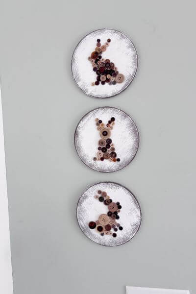 Three wood rounds with brown button bunnies