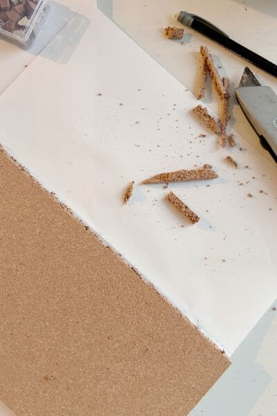 Cutting the third cork board with the utility knife.