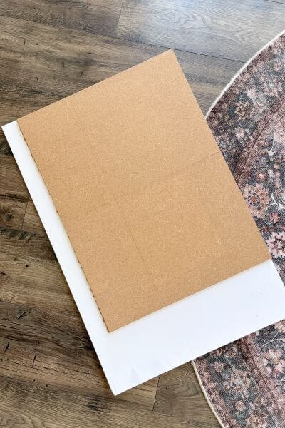 Remove the plastic to expose the adhesive and apply the third cork pieces below the other two.