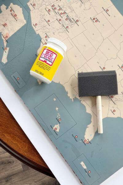 Apply a thin layer of mod podge with foam brush.