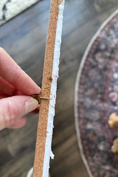 Picture shows how the push pin extends through the cork and into the foam board.