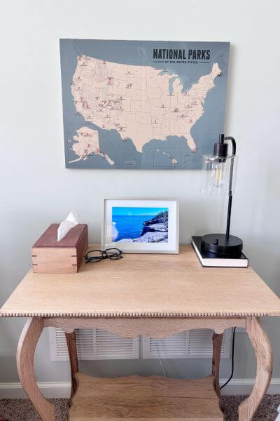 Push pin travel map hanging above small table.