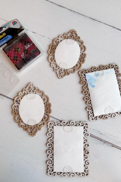 Glue dots secured to the back of the frames for hanging.