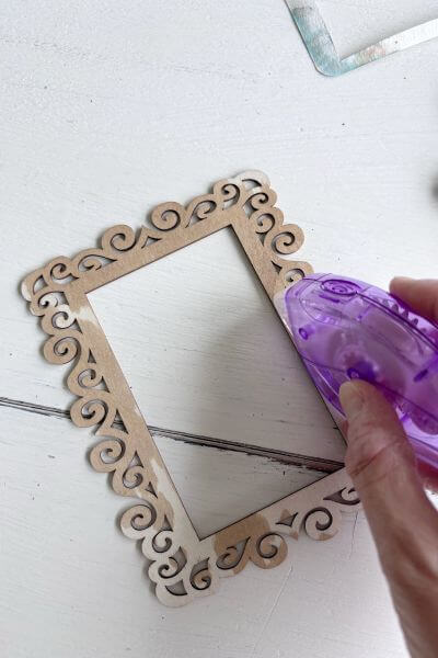 Run the tacky dot runner along the inside edge of the frame.