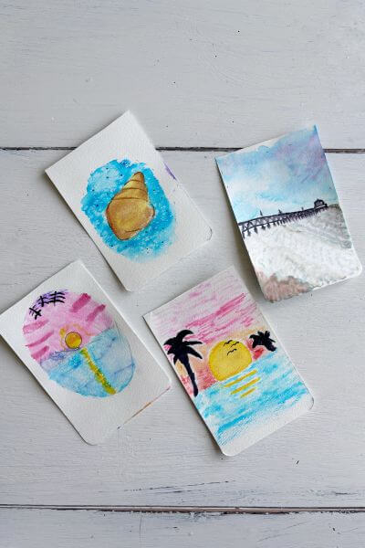 Four watercolor beach scene pictures.