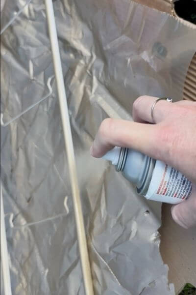 Spray paint the sides of the upright parts of the stand.