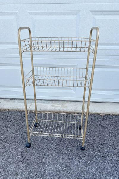 Wire plant stand painted gold and assembled with third shelf removed.